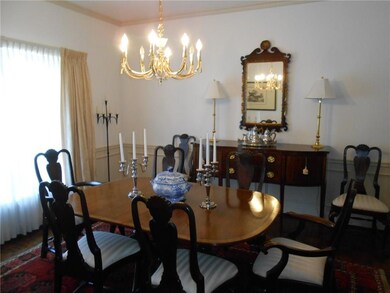Formal dining rm with chair rail and bay window.