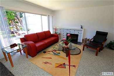 Living Room offers fireplace and scraped ceilings