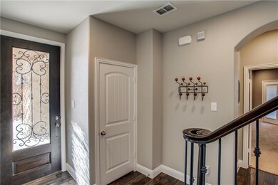 Nice entryway with wood floors coat closet and lar