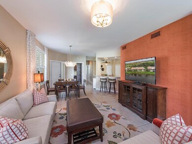Another view of open floor plan with ALL NEUTRAL TILED living/dining/lanai floors.  New lighting fixture  & cheerful grass paper wall.  This is Turnkey furnished complete with 55