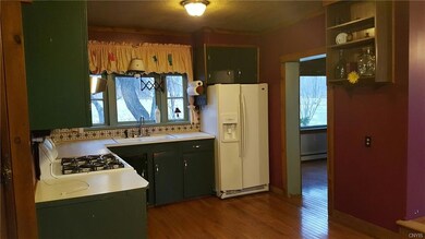 Open floor plan with this home gas stove, wood flo