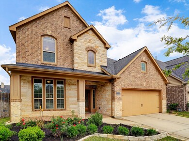 The warm & inviting covered front porch with pretty landscaping makes this home's curb appeal very attractive.