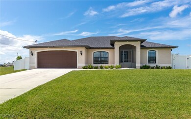 View of front of house featuring stucco siding, a