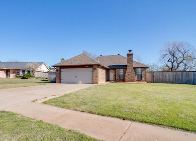 Ranch-style house featuring a garage and a front y