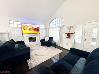 Living room with dark wood-style flooring, high va