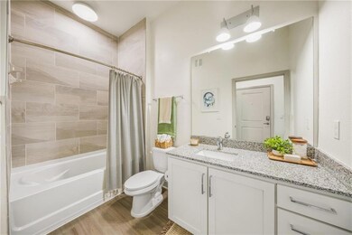 Full bathroom with wood-type flooring, vanity with