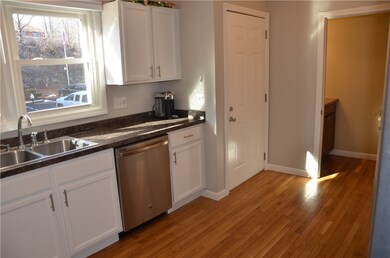 The hardwood flooring continues into the half bath