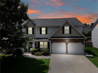 View of front of home featuring a garage, driveway, and roof with shingles