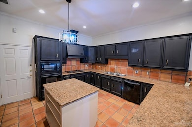 Kitchen featuring dark cabinetry, ornamental molding, decorative backsplash, a kitchen island, and light tile patterned floors
