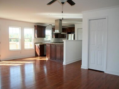 Spacious living area. Split floor plan.Hall leading to extra bedroms, 1 bath, and utility.