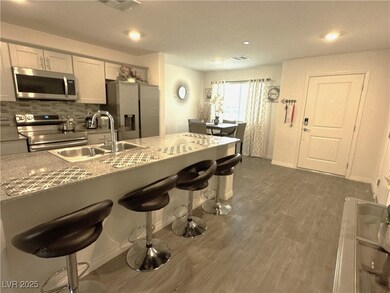 Kitchen with visible vents, a sink, a kitchen brea