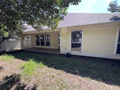 Rear view of house featuring a lawn