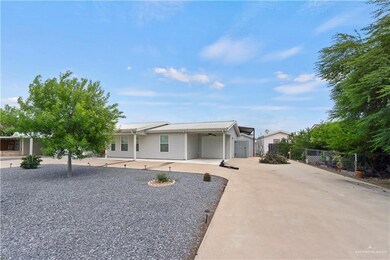 Ranch-style house with concrete driveway, ceiling fan, and a garage