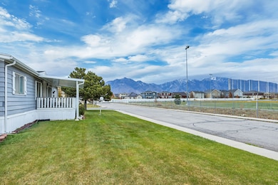 View of asphalt road with a residential view, a mountain view, curbs, and street lighting