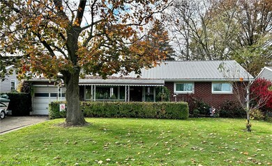 Ranch-style home with a front lawn and a garage