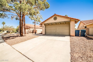 Mediterranean / spanish-style home with stucco siding, driveway, and a tiled roof
