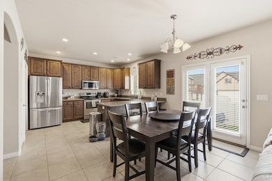 Dining space with recessed lighting, light tile patterned floors, and a chandelier