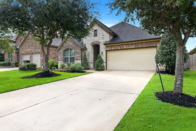 The large driveway offers ample guest parking or space for front yard play on this low-traffic street, leading up to a single garage door for the two-car garage.