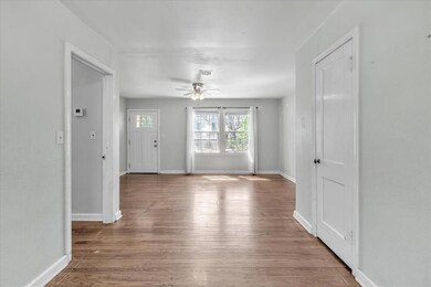 Spare room with ceiling fan and hardwood / wood-st