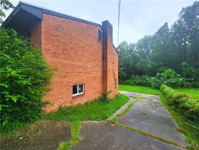 View of side of home featuring a yard
