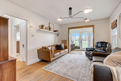 The living room boasts original hardwood floors that extend throughout much of the main level, creating a warm and timeless ambiance.