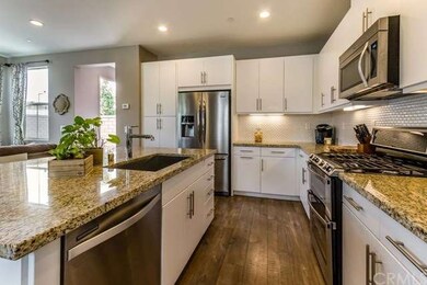 Stainless steel appliances and wood laminate floor