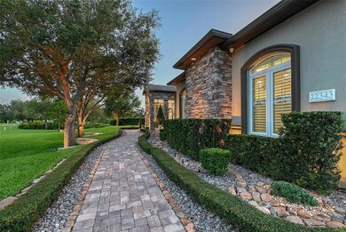 Paver walkway and shrubbery frame this gorgeous home