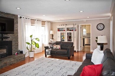 Spacious family room with a wood burning fireplace insert with a vent
