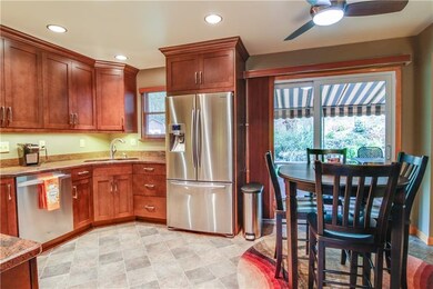 This fabulous eat-in-kitchen offers access to the covered private deck via an updated 8' sliding glass door.