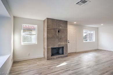 Unfurnished living room with light wood-style floo