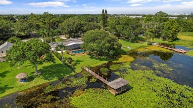 As you step onto the covered lanai, you'll be captivated by the PANORAMIC VIEWS that extend beyond the private SCREENED IN POOL and out to the COVERED DOCK!