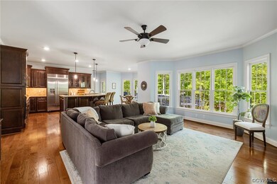 Family room features hardwood floors, a gas firepl