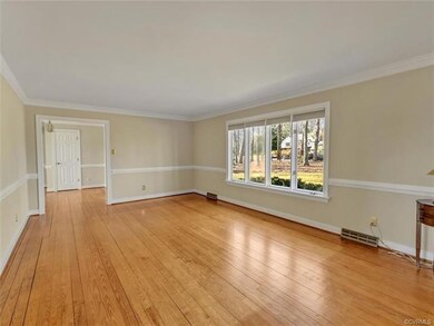 Living room has chair rail and crown moulding.