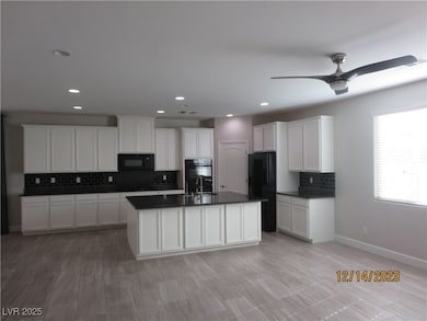 Kitchen featuring dark countertops, a kitchen isla