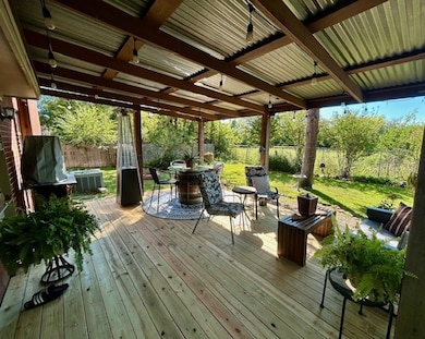 Wooden terrace featuring a fenced backyard, outdoor dining space, and an outdoor living space