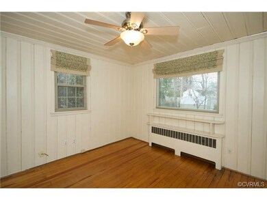 The family room has hardwood floors and a ceiling 