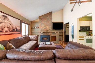 Living area with a gas fireplace, wood finished fl