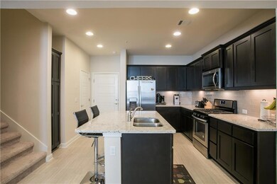 Kitchen featuring stainless steel appliances, a b