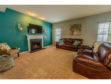 THE FAMILY ROOM IS ANCHORED BY A COZY GAS FIREPLAC