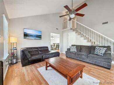 Living area featuring visible vents, baseboards, s