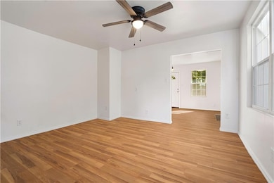 Spare room with light wood finished floors and ceiling fan