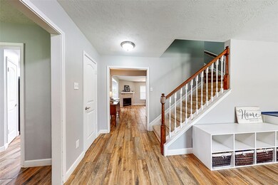 The entry opens to the formal living and dining area and leads to the family room.