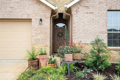 Property entrance featuring an attached garage an