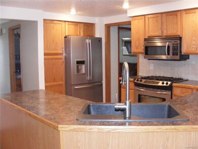 Kitchen with stainless appliances, pantry, & reces