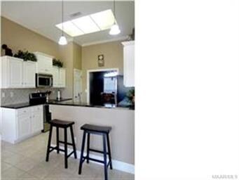 Kitchen has granite countertops with tiled backspl