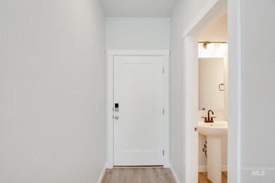 Hall with light wood-style flooring and baseboards