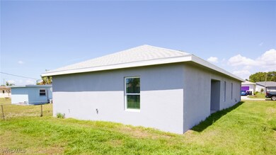 View of property exterior featuring a lawn, stucco