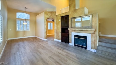 Unfurnished living room featuring a high ceiling,