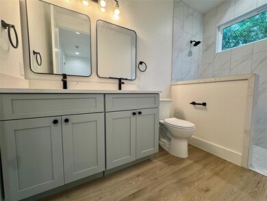 Full bathroom featuring walk in shower, wood fini