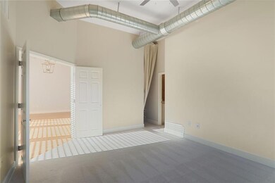 Carpeted empty room featuring baseboards, a high c